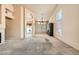 Bright, carpeted living room with fireplace and view into another room at 9532 Calico Garden Ave, Las Vegas, NV 89134