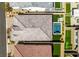 Aerial view showcases a neatly tiled roof alongside a vibrant backyard featuring a pool, hot tub, and putting green at 9974 Petroglyph Canyon Ave, Las Vegas, NV 89166