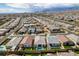 Expansive aerial view of a Nevada neighborhood featuring well-maintained homes and desert landscaping under a partly cloudy sky at 9974 Petroglyph Canyon Ave, Las Vegas, NV 89166
