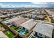 Beautiful aerial view of a planned community featuring a backyard pool, hot tub, and putting green at 9974 Petroglyph Canyon Ave, Las Vegas, NV 89166