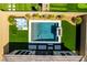 Aerial shot of backyard oasis featuring a sparkling pool, modern hot tub, lush artificial turf, and cozy fire feature at 9974 Petroglyph Canyon Ave, Las Vegas, NV 89166