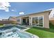 Gorgeous backyard featuring a luxurious pool, spa, and artificial grass creating a serene oasis at 9974 Petroglyph Canyon Ave, Las Vegas, NV 89166