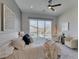 Luxurious bedroom with backyard view, patio access, and cozy seating area at 9974 Petroglyph Canyon Ave, Las Vegas, NV 89166