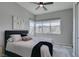 Bright bedroom featuring large windows, a ceiling fan, and plush bedding at 9974 Petroglyph Canyon Ave, Las Vegas, NV 89166