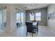 Elegant dining room with modern lighting, sleek furnishings, and sliding glass doors opening to the outdoor area at 9974 Petroglyph Canyon Ave, Las Vegas, NV 89166