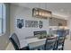 Contemporary dining room with stylish light fixture and modern art at 9974 Petroglyph Canyon Ave, Las Vegas, NV 89166