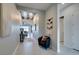Inviting entryway with neutral walls, wood-look tile floors, modern decor, and seamless transition to living spaces at 9974 Petroglyph Canyon Ave, Las Vegas, NV 89166