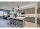 Bright kitchen with island seating, stainless appliances, and adjacent dining area at 9974 Petroglyph Canyon Ave, Las Vegas, NV 89166