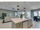 Modern kitchen island with sink, dishwasher, and open view to the living and dining area at 9974 Petroglyph Canyon Ave, Las Vegas, NV 89166