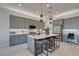 Modern kitchen with gray cabinetry, stainless steel appliances, and center island at 9974 Petroglyph Canyon Ave, Las Vegas, NV 89166