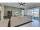 Bright living room with a sectional sofa, neutral decor, and large sliding glass doors to the backyard at 9974 Petroglyph Canyon Ave, Las Vegas, NV 89166