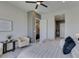 Relaxing main bedroom featuring a ceiling fan, a comfy chair, and a doorway to the main bathroom at 9974 Petroglyph Canyon Ave, Las Vegas, NV 89166