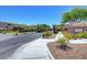 Well-maintained community entrance featuring lush landscaping and signage at 11036 Mount Hunter St, Las Vegas, NV 89179