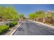 Gated community entrance with desert landscaping, mature trees, and well-maintained surroundings at 11036 Mount Hunter St, Las Vegas, NV 89179