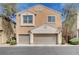 Exterior shot of a townhome with multiple garage doors and lush landscaping at 11036 Mount Hunter St, Las Vegas, NV 89179