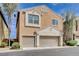 Two-story home featuring a two-car garage and neutral-colored stucco exterior under a blue sky at 11036 Mount Hunter St, Las Vegas, NV 89179