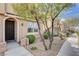 Charming townhome featuring an arched front door, desert landscaping, and a sidewalk at 11036 Mount Hunter St, Las Vegas, NV 89179