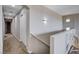 Hallway with neutral paint, carpet, closet, and stairway leading to the lower level at 11036 Mount Hunter St, Las Vegas, NV 89179