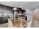 Well-lit kitchen with stainless steel appliances and a wooden dining table set at 11036 Mount Hunter St, Las Vegas, NV 89179