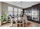 Kitchen with dining area, dark wood cabinets, and stainless steel oven appliances at 11036 Mount Hunter St, Las Vegas, NV 89179