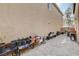 View of the outdoor patio with stone pavers, plants, and exterior wall at 11036 Mount Hunter St, Las Vegas, NV 89179