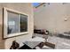 View of outdoor patio with table and chairs, stone pavers, and exterior window at 11036 Mount Hunter St, Las Vegas, NV 89179
