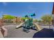 Community playground featuring slides and climbing structures in a secure, fenced area, perfect for Gathering fun at 11036 Mount Hunter St, Las Vegas, NV 89179