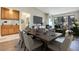 Open-concept dining area with sleek table, seating for six, bar, and views of the outdoor living space at 2723 Seabridge Dr, Las Vegas, NV 89121