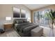 Modern bedroom featuring large bed, art, sliding doors, and lots of natural light at 2723 Seabridge Dr, Las Vegas, NV 89121