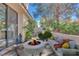 Cozy outdoor patio area featuring a stone fire pit, sofa, lush plants and mature shade trees at 2723 Seabridge Dr, Las Vegas, NV 89121