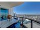 Balcony with an outdoor dining set, offering expansive city and mountain views at 322 Karen Ave # 4207, Las Vegas, NV 89109
