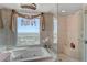 This bathroom offers a bath with a view and a glass enclosed shower at 322 Karen Ave # 4207, Las Vegas, NV 89109