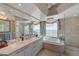 This bathroom includes a dual sink vanity, bath, and glass shower at 322 Karen Ave # 4207, Las Vegas, NV 89109
