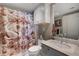 This bathroom is nicely decorated with a swan shower curtain and storage at 322 Karen Ave # 4207, Las Vegas, NV 89109