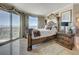 Bedroom featuring large windows with city views, ornate furnishings, and marble floors at 322 Karen Ave # 4207, Las Vegas, NV 89109
