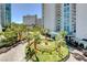 Building exterior view featuring a circular driveway, lush landscaping, and an inviting entrance at 322 Karen Ave # 4207, Las Vegas, NV 89109