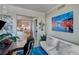 Sitting area in an office space with artwork, desk, and a partial view into the kitchen area at 322 Karen Ave # 4207, Las Vegas, NV 89109
