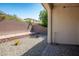 Low maintenance backyard with small plants and a retaining wall creating a private outdoor space at 4032 Little Bay Ave, North Las Vegas, NV 89081