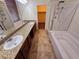 Bright bathroom boasts double sinks, granite counters, and a separate tub-shower with a glass enclosure at 4032 Little Bay Ave, North Las Vegas, NV 89081