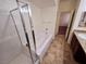 Bathroom featuring a shower-over-tub with glass doors, single sink and granite counter at 4032 Little Bay Ave, North Las Vegas, NV 89081