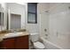 Bright bathroom featuring vanity with granite counters, bathtub, and a shower with white tiles at 4032 Little Bay Ave, North Las Vegas, NV 89081