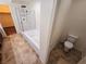 Well-lit bathroom with tile floors, a shower over tub, and a separate toilet area at 4032 Little Bay Ave, North Las Vegas, NV 89081