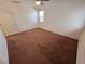 Neutral-toned bedroom with carpeted flooring, one window with blinds, and a ceiling fan at 4032 Little Bay Ave, North Las Vegas, NV 89081