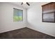 Clean, carpeted bedroom featuring neutral walls, window blinds, and a ceiling fan at 4032 Little Bay Ave, North Las Vegas, NV 89081