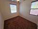 Bedroom with two windows, plush carpeting, and ceiling fan with lights at 4032 Little Bay Ave, North Las Vegas, NV 89081