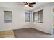 Spacious bedroom with tile and carpet flooring, a ceiling fan, and a sliding glass door at 4032 Little Bay Ave, North Las Vegas, NV 89081
