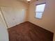 Carpeted bedroom offers dual closets and natural light with overhead lighting at 4032 Little Bay Ave, North Las Vegas, NV 89081