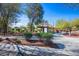 Scenic community park with walking paths, mature trees, lush greenery, and a covered information kiosk at 4032 Little Bay Ave, North Las Vegas, NV 89081