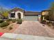 Charming single story home with a welcoming entrance, brick driveway and a two-car garage at 4032 Little Bay Ave, North Las Vegas, NV 89081