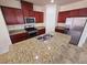 Well-equipped kitchen with granite countertops, a center island sink, stainless steel appliances, and ample cabinet space at 4032 Little Bay Ave, North Las Vegas, NV 89081